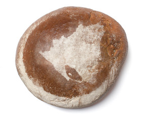 A loaf of fresh bread covered with rye flour in the shape of Nic