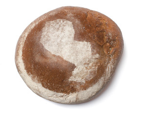 A loaf of fresh bread covered with rye flour in the shape of Par