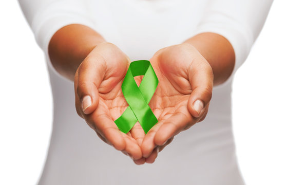 Hands Holding Green Awareness Ribbon