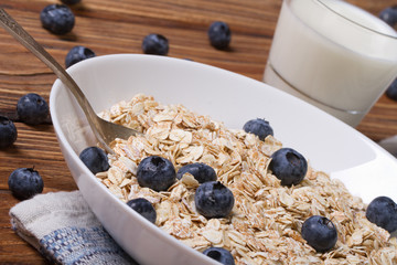 oatmeal with blueberries and milk in a glass horizontal