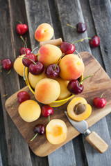 Fresh apricot and cherry in a bucket