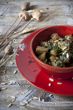 roasted japanese turnips with leaves and seeds on red bowl