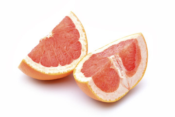 Slices of grapefruit on a white background.