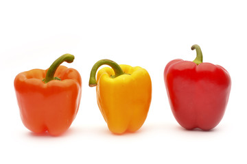 Red, orange and yellow capsicum on a white background