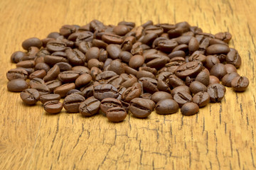 Coffee beans on old wooden background