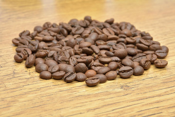 Coffee beans on old wooden background