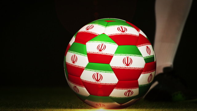 Football player kicking iran flag ball