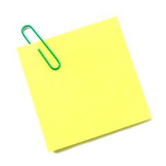 Blank post it note with green paper clip isolated on white