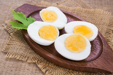 Boiled eggs on wooden plate
