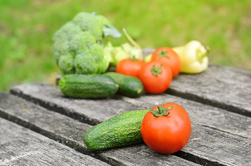 Fresh vegetable mix on wooden background