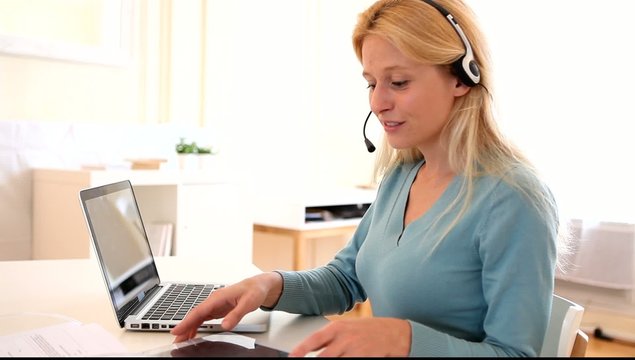 Young attractive woman blonde chatting on laptop