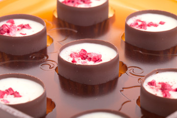 Chocolates with raspberries in a plastic blister pack