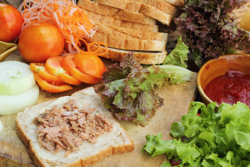 making tuna sandwich with fresh vegetables