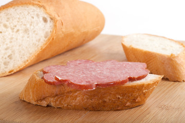 sandwich with boiled-smoked sausage on wood