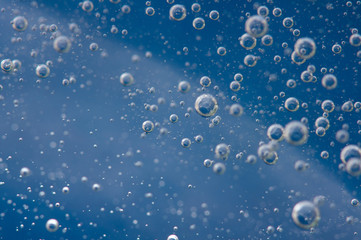 Air bubbles in a liquid. Abstract blue background. Macro