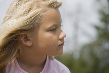 Thoughtful looking young girl outdoors