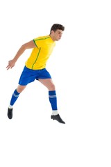 Fototapeta na wymiar Football player in yellow jumping