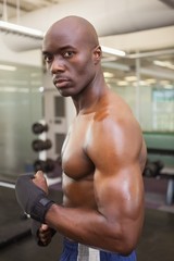 Fototapeta na wymiar Shirtless muscular man standing in gym