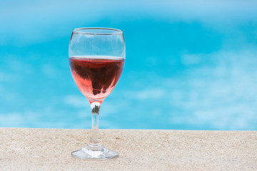 Glass of wine in the pool