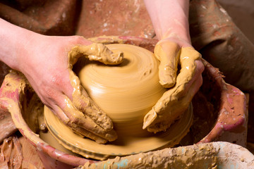 hands of a potter, creating an earthen jar