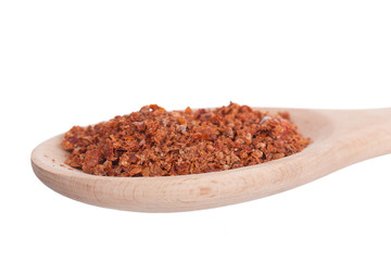Paprika in a wooden spoon, it is isolated on a white background