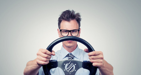 Funny man in glasses with a steering wheel, car drive concept