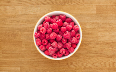 Raspberries on wooden table. Healthy food
