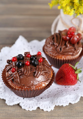 Tasty cupcakes on wooden background