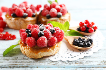 Sweet cakes with berries on table close-up