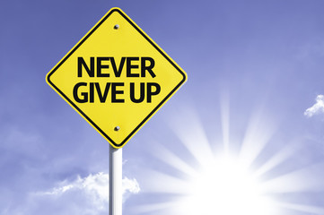 Never Give Up road sign with sun background