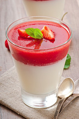 Dessert Panna Cotta with fresh strawberry on old wooden backgrou