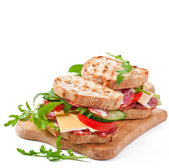 Sandwich with ham, cheese and fresh vegetables on white backgrou