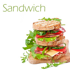 Sandwich with ham, cheese and fresh vegetables on white backgrou