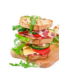 Sandwich with ham, cheese and fresh vegetables on white backgrou