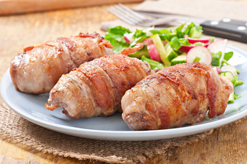 Grilled meat rolls wrapped in strips of bacon
