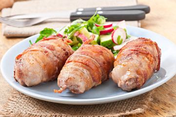 Grilled meat rolls wrapped in strips of bacon