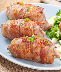 Grilled meat rolls wrapped in strips of bacon