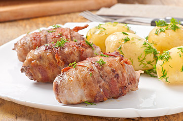 Grilled meat rolls wrapped in strips of bacon