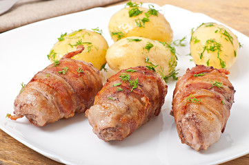 Grilled meat rolls wrapped in strips of bacon