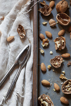 composition with cracked walnuts and almonds with nutcracker