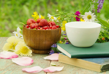 Books, flowers and white cup