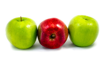 a red apple among green apple on the right and left isolated on