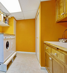 Bright yellow laundry room interior