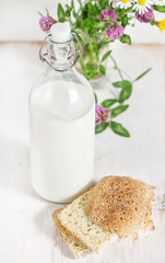 Fresh milk in old fashioned bottle and homemade bread