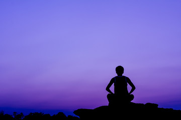 Silhouette of a man in meditation posting