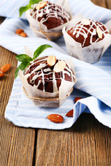 Tasty cupcakes with nuts on table close-up