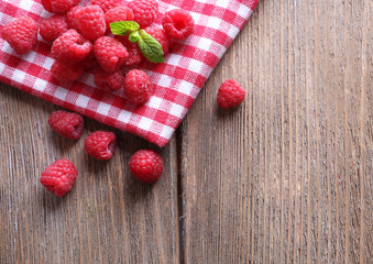 Ripe sweet raspberries on table close-up
