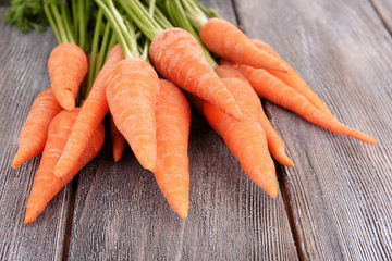 Fresh carrot on wooden background