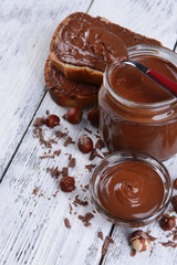Sweet chocolate cream in jar on table close-up