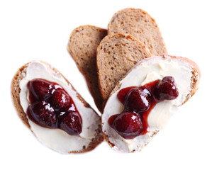 Fresh bread with strawberry jam and homemade butter, isolated